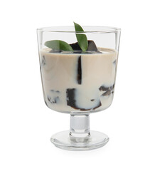 Glass of milk with grass jelly and green leaves isolated on white