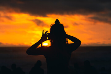 Naklejka premium Person Takes Photo of Tropical Sunset