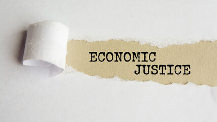 economic justice. words. text on gray paper on torn paper background