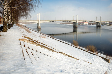 Fototapeta na wymiar View of the road bridge across the Volga in the city of Kimry on a winter day. The longest bridge in the Tver region