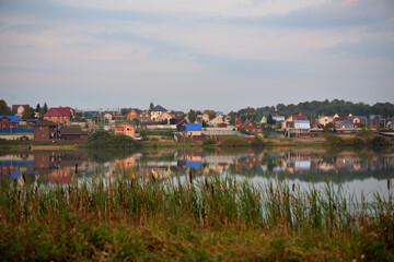 View of village Vasilievskoye on banks of  Imbushka river on sunny autumn day, Sergiev Posad district, Moscow region, Russia