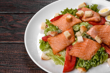 Delicious fresh salad with red fish for the festive table