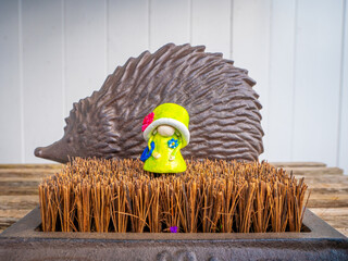 Queen Gnome in front of a Metal Hedgehog in the Garden