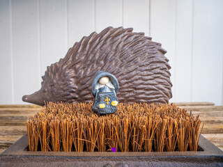 Preacher Gnome in front of a Metal Hedgehog in the Garden
