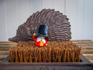 Beefeater British Royal Guard in front of a hedgehog for cleaning shoes
