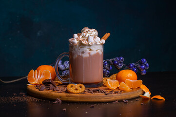 A mug of hot chocolate with cream and cinnamon stick marshmallow