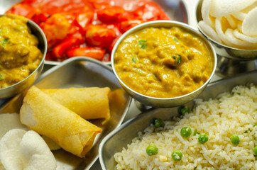 Chinese set,  chicken curry, sweet and sour chicken served with egg fried rice, vegetable spring rolls, and prawn crackers