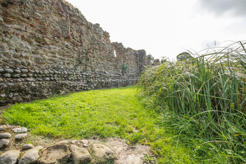 The stone and flint remains of a medieval disused and derelict castle in rural England. A well...