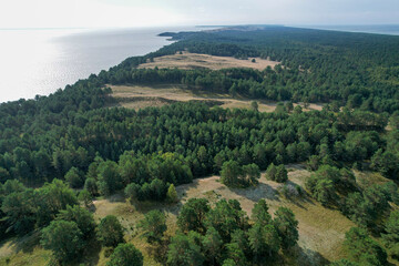 Aerial view with dunes, forest and sea in Curonian spit on a sunny day photographed with a drone. The Curonian Spit lagoon is a Unesco world heritage site. Gray Dunes, Dead Dunes. 