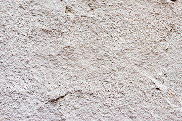 Texture of a concrete wall with cracks and scratches which can be used as a background