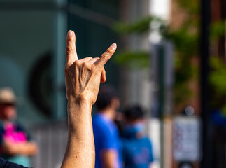 Hand gesture indicating love by a woman peaceful protester in Asheville, NC