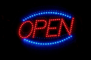 Red and blue open sign welcomes customers