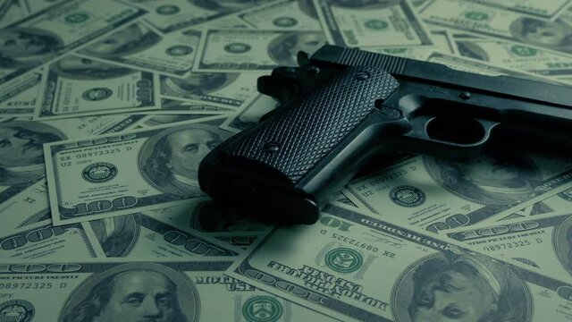 Lots Of Cash With Gun On Top