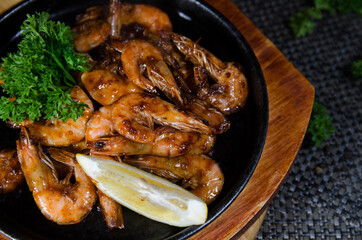 grilled shrimps with lemon on a wooden board, chinese cuisine