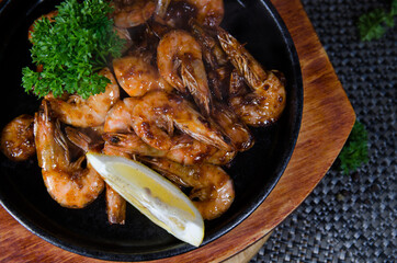 grilled shrimps with lemon on a wooden board, chinese cuisine