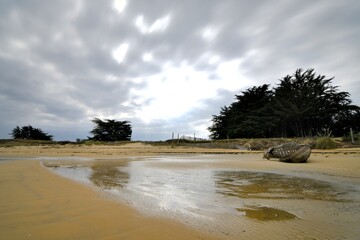 Wreck in wood on a beach at the Ria d'Etel in Brittany. France