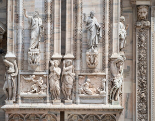 Fototapeta premium marble statues on the facade of the cathedral, Duomo in Milan, Italy