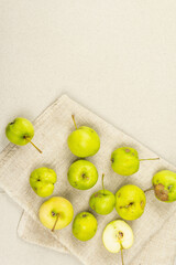 Trendy ugly organic apples on stone concrete background