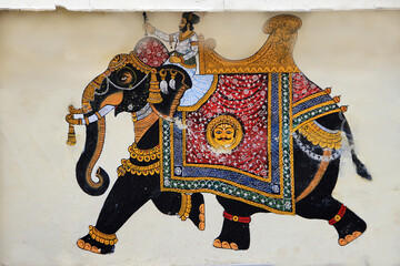 Painting of king riding decorated royal elephant at City Palace in Udaipur, Rajasthan, India