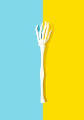 Skeleton hand on creative and modern background. Halloween concept. 