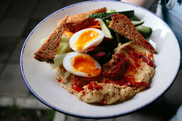 Hummus plate with boiled egg and rye bread