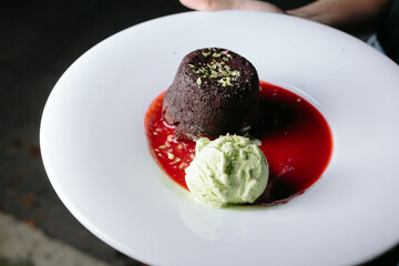 cream with chocolate  fondant and strawberry sauce
