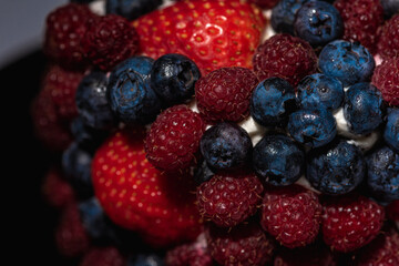 Cake with berries, blueberries, strawberries on a light background, close-up view. Summer berry cake concept