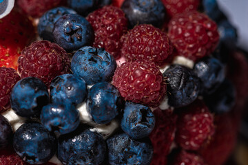 top view of cake with berries, blueberries, strawberries on a light background, close up view. Summer berry cake concept