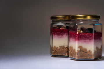 Blurry tiramisu in a glass jar, on a white background. focus selection.