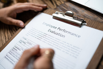 Person Filling A Performance Evaluation Form