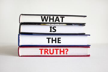 What is the truth symbol. Concept words 'What is the truth' on books on a beautiful white...