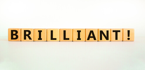 Brilliant symbol. The word brilliant on wooden cubes. Beautiful white table, white background. Business and brilliant concept. Copy space.