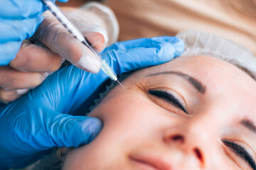 Botox injection into mimic wrinkles by a student trainee in a beauty parlor. Education
