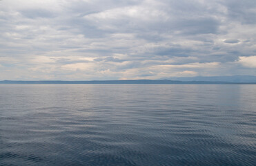 calm blue sea and cloudy sky
