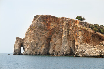 Fototapeta na wymiar rock with the grotto in the sea