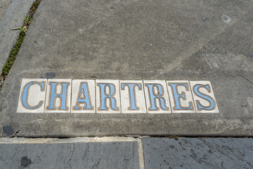 Traditional Chartres Street Tile Inlay on Sidewalk in French Quarter in New Orleans, Louisiana, USA