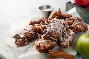 Homemade Apple fritters topped white glaze drizzle, selective focus