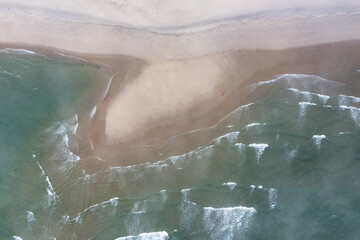 The cold, nutrient-filled water of the Atlantic Ocean washes onto a scenic beach in Chatham, Cape Cod, Massachusetts. This beautiful peninsula is a popular vacation destination during summer months.