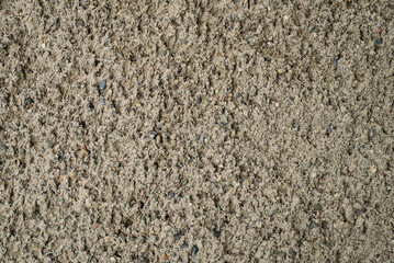 Background. Gray sand with small stones. Abstract texture.