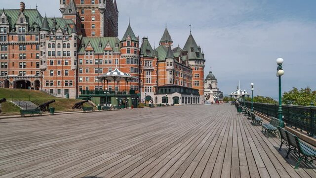 Zoom out timelapse view of tourists sightseeing at Dufferin Terrace during summer in Old Quebec, Canada.