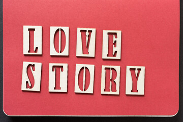 the expression "love story" in stencil font on red endpapers