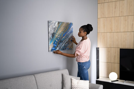 Smiling Woman Hanging Painting