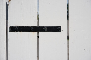 white plank fence with metal bracket