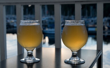 Two glasses of ale served at balcony facing Port Ludlow moorage