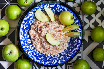 Oatmeal porridge and apples in a bowl