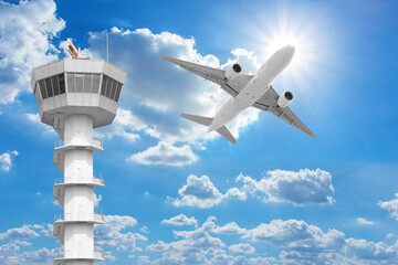  Passenger aircraft  flying above air traffic control tower against blue sky