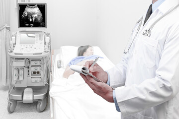 Obraz na płótnie Canvas Doctor recording check health obstetric ultrasound of fetus by ultrasonic scan for diagnose the condition of a pregnant woman on the computer screen