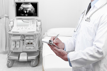 Doctor recording check health obstetric ultrasound of fetus by ultrasonic scan for  diagnose the condition on the computer screen