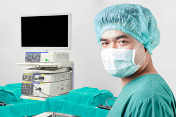 Surgeon looking at camera and equipment tools in operating room