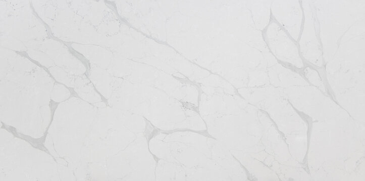 This quartz slab has an off-white background with soft light grey veins inspired by Statuario marble
